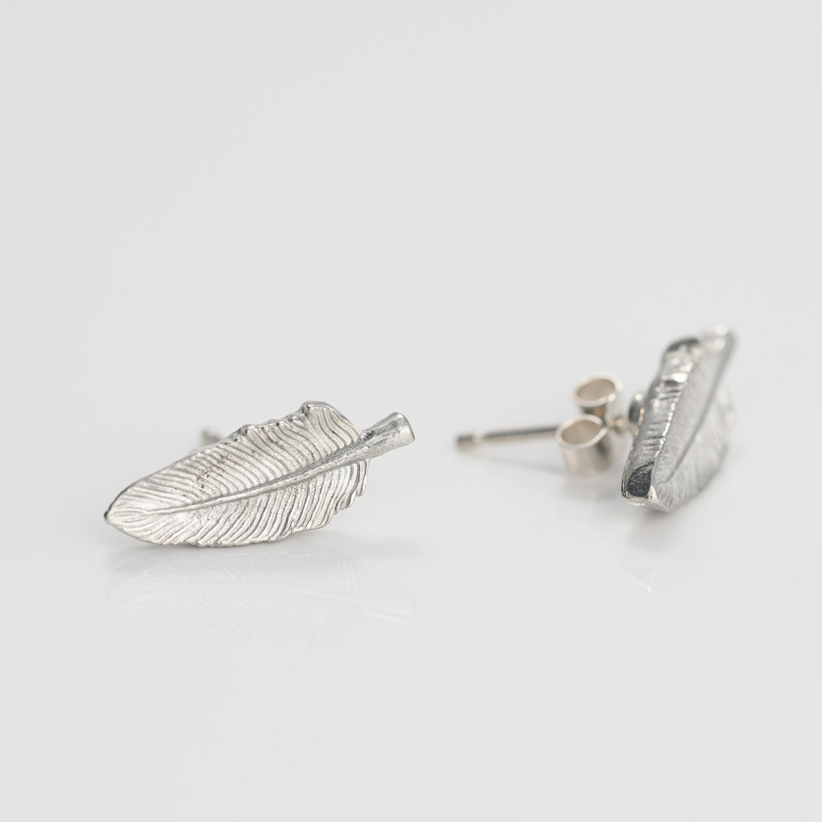 Silver feather stud earrings store